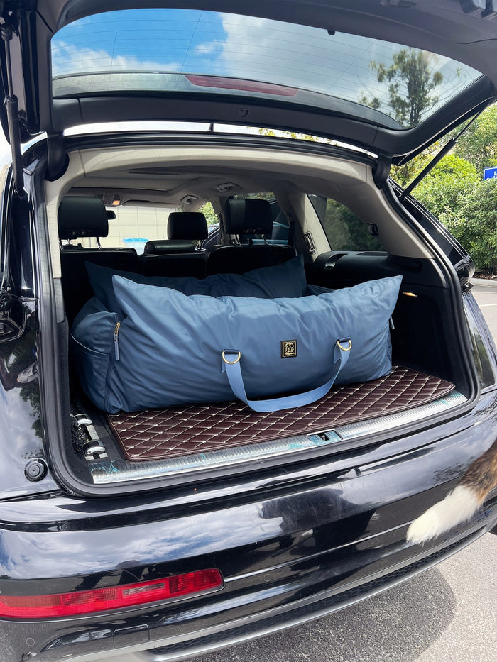XL navy petsperro dog car seat bed placed in an SUV trunk, sized for large dogs on long road trips