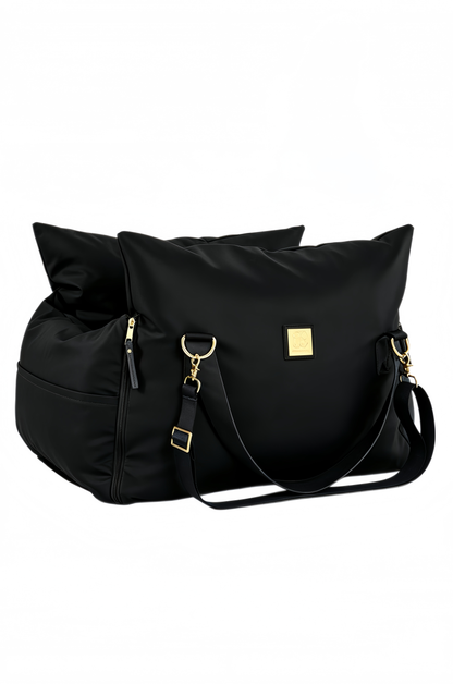 Black petsperro dog car seat folded into carry-bag shape with shoulder strap and gold hardware