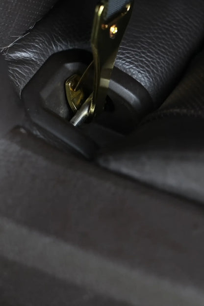 Metal spring hook of the petsperro dog car seat clipped onto a car's ISOFIX anchor point in the back seat