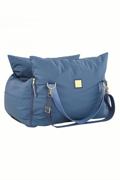Navy petsperro dog car seat folded into carry-bag shape with shoulder strap and gold hardware