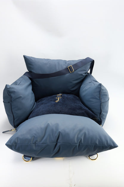 Navy petsperro dog car seat with the removable base cushion pulled out in front of the cover