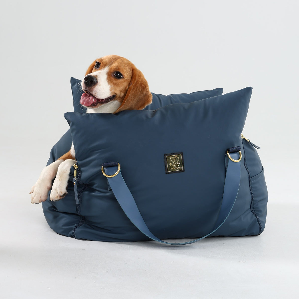 Beagle sitting in the navy petsperro luxury dog car seat, size Medium, front view on a white background